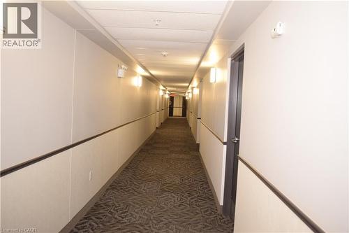 Hall featuring a decorative wall and dark carpet - 776 Laurelwood Drive Unit# 406, Waterloo, ON - Indoor Photo Showing Other Room