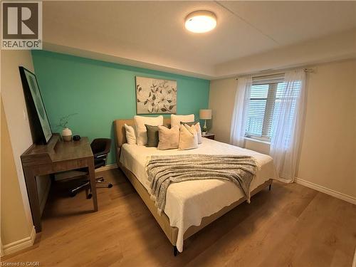 Bedroom featuring wood finished floors - 776 Laurelwood Drive Unit# 406, Waterloo, ON - Indoor Photo Showing Bedroom