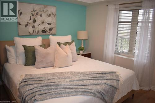 Bedroom with wood finished floors - 776 Laurelwood Drive Unit# 406, Waterloo, ON - Indoor Photo Showing Bedroom