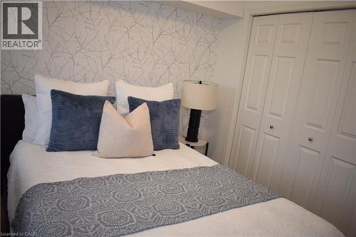 Bedroom with wallpapered walls and a closet - 776 Laurelwood Drive Unit# 406, Waterloo, ON - Indoor Photo Showing Bedroom
