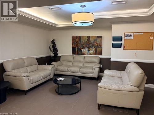 Tiled living room with ornamental molding and a tray ceiling - 776 Laurelwood Drive Unit# 406, Waterloo, ON - Indoor Photo Showing Living Room