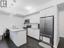 Kitchen with a peninsula, stainless steel appliances, white cabinets, and backsplash - 1206 Main Street E Unit# 113, Milton, ON  - Indoor Photo Showing Kitchen 