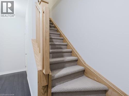 Stairway featuring baseboards and wood finished floors - 1206 Main Street E Unit# 113, Milton, ON - Indoor Photo Showing Other Room