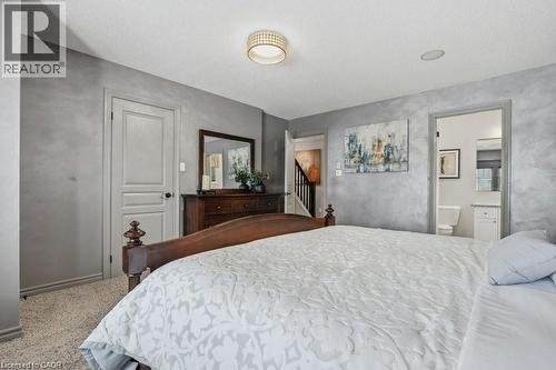 Impressive primary bedroom with walk-in closet and private ensuite - 26 Helena Feasby Street, Kitchener, ON - Indoor Photo Showing Bedroom