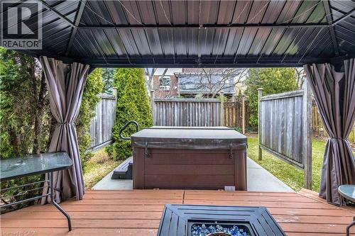Wooden deck featuring a fenced backyard and a hot tub - 640 Acadia Drive, Hamilton, ON - Outdoor With Exterior