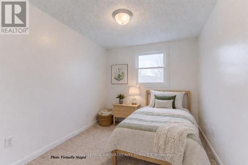 **photo virtually staged - 828 Elgin Street N, Cambridge, ON - Indoor Photo Showing Bedroom
