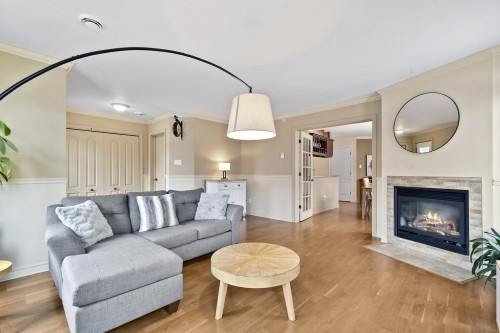 Salon - 102-50 37E Avenue E., Blainville, QC - Indoor Photo Showing Living Room With Fireplace