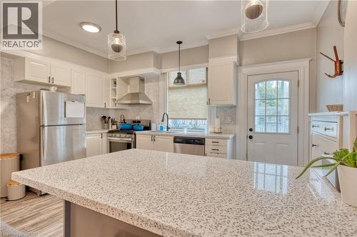 Kitchen featuring stainless steel appliances, white cabinetry, hanging light fixtures, light stone counters, and backsplash - 37 Cliff Avenue, Hamilton, ON - Indoor Photo Showing Kitchen