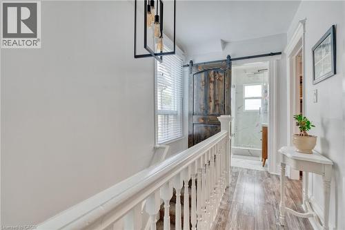 Hallway with a barn door and light wood finished floors - 37 Cliff Avenue, Hamilton, ON - Indoor Photo Showing Other Room