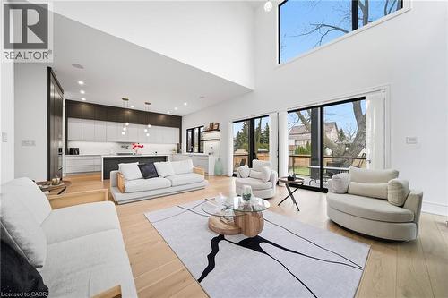 Living area featuring light wood-style flooring and a high ceiling - 2556 Glengarry Road, Mississauga, ON - Indoor Photo Showing Living Room