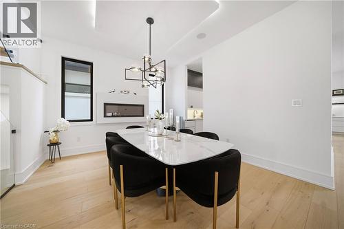 Dining room with suspended lighting and light wood finished floors - 2556 Glengarry Road, Mississauga, ON - Indoor Photo Showing Dining Room