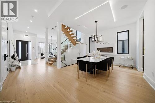 Dining area with hanging lights and light wood finished floors - 2556 Glengarry Road, Mississauga, ON - Indoor