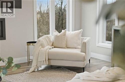 Living area featuring baseboards and wood finished floors - 39 Mill Race Crescent, St. Jacobs, ON - 