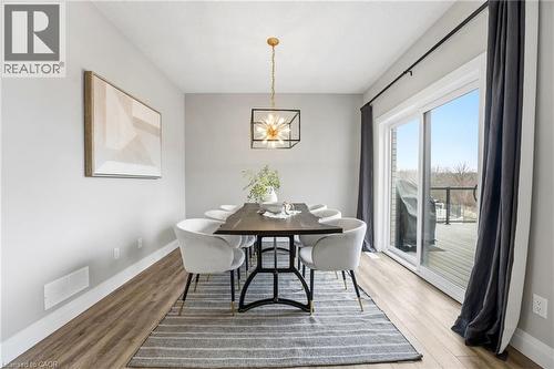 Dining space with wood finished floors and suspended lighting - 39 Mill Race Crescent, St. Jacobs, ON - Indoor Photo Showing Dining Room