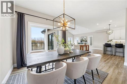 Dining area featuring suspended lighting, light wood finished floors, and vaulted ceiling - 39 Mill Race Crescent, St. Jacobs, ON - Indoor Photo Showing Dining Room