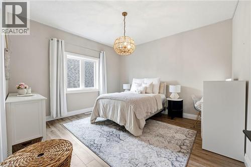 Bedroom with light wood-style flooring and suspended lighting - 39 Mill Race Crescent, St. Jacobs, ON - Indoor Photo Showing Bedroom