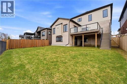 Back of house with a fenced backyard, brick siding, a wooden deck, and a gate - 39 Mill Race Crescent, St. Jacobs, ON - Outdoor With Deck Patio Veranda
