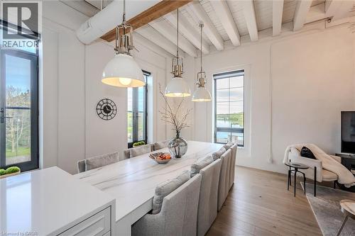 Dining area with light wood-style floors and beam ceiling - 19 Guelph Avenue Unit# 308, Cambridge, ON - Indoor
