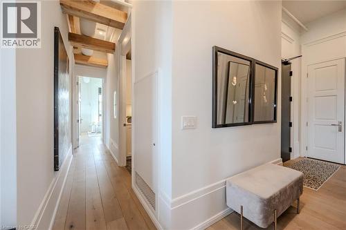 Hall featuring light wood-style flooring and beamed ceiling - 19 Guelph Avenue Unit# 308, Cambridge, ON - Indoor Photo Showing Bedroom