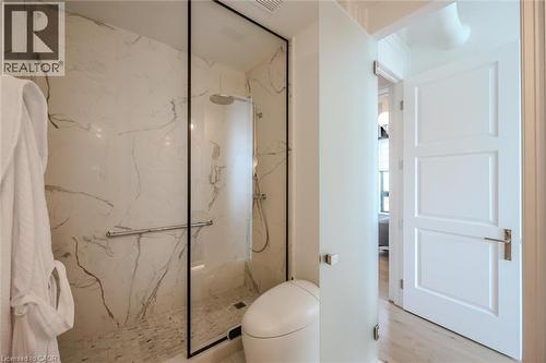 Bathroom featuring toilet and a marble finish shower - 19 Guelph Avenue Unit# 308, Cambridge, ON - Indoor Photo Showing Bathroom