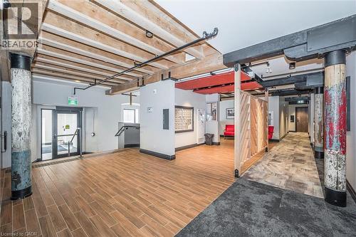 Below grade area with wood tiled floors and baseboards - 19 Guelph Avenue Unit# 308, Cambridge, ON - Indoor