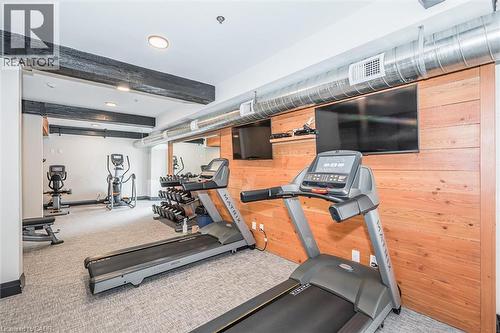 Exercise area with wood walls, beam ceiling, and recessed lighting - 19 Guelph Avenue Unit# 308, Cambridge, ON - Indoor Photo Showing Gym Room
