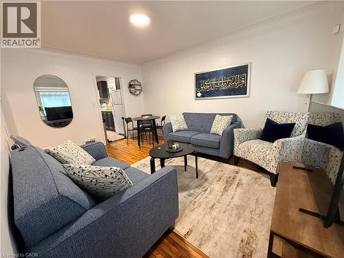 Living area featuring light wood-type flooring and crown molding - 501 Upper Wellington Street, Hamilton, ON - Indoor Photo Showing Living Room