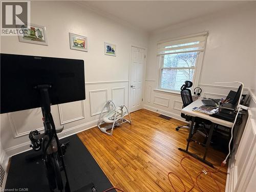 Office space with light wood-style flooring, a decorative wall, wainscoting, and ornamental molding - 501 Upper Wellington Street, Hamilton, ON - Indoor Photo Showing Office