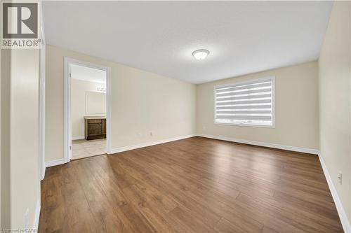 Empty room with dark wood-style flooring and baseboards - 51 Seabrook Drive, Kitchener, ON - Indoor Photo Showing Other Room