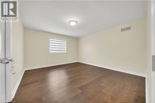 Unfurnished room featuring dark wood-style flooring and a textured ceiling - 51 Seabrook Drive, Kitchener, ON - Indoor Photo Showing Other Room