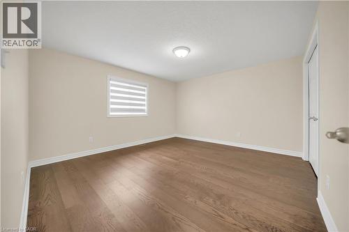 Unfurnished room with dark wood-style floors and a textured ceiling - 51 Seabrook Drive, Kitchener, ON - Indoor Photo Showing Other Room