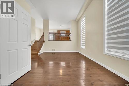 Unfurnished living room with dark wood-type flooring and healthy amount of natural light - 51 Seabrook Drive, Kitchener, ON - Indoor Photo Showing Other Room