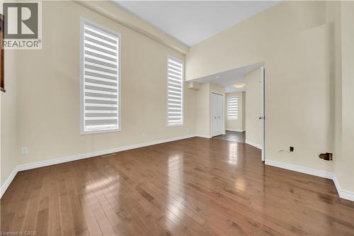Unfurnished room featuring baseboards and dark wood finished floors - 51 Seabrook Drive, Kitchener, ON - Indoor Photo Showing Other Room