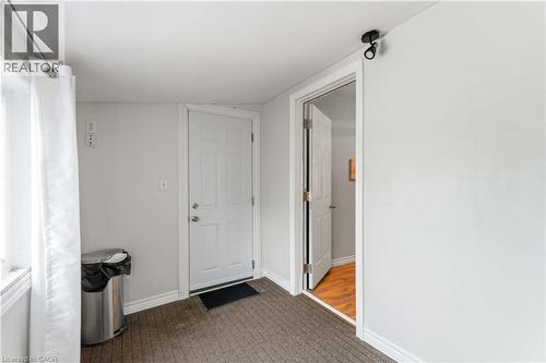 Entryway featuring dark carpet and baseboards - 74 Province Street N, Hamilton, ON - Indoor Photo Showing Other Room