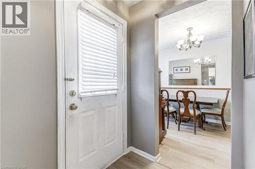 Entrance foyer featuring light wood finished floors, a chandelier, and crown molding - 2145 Sandringham Drive, Burlington, ON - Indoor Photo Showing Other Room