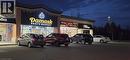 Property at twilight featuring view of commercial area and uncovered parking - 645 Westmount Road E Unit# 8, Kitchener, ON 