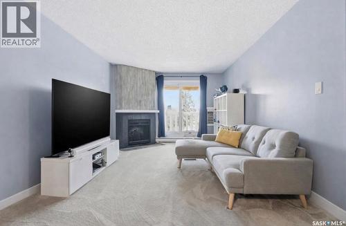 135 310 Stillwater Drive, Saskatoon, SK - Indoor Photo Showing Living Room With Fireplace