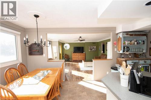 Dining room featuring a ceiling fan, ornamental molding, and a chandelier - 535 Mcdowell Road E, Simcoe, ON 