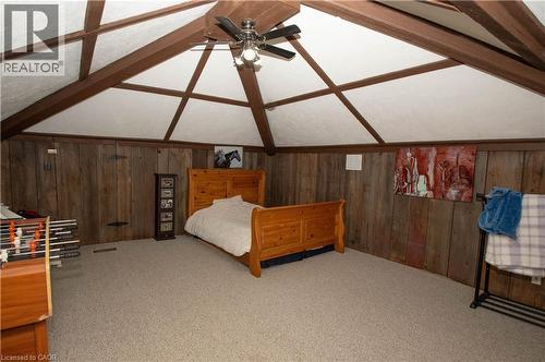 Bedroom featuring wood walls, carpet floors, and ceiling fan - 535 Mcdowell Road E, Simcoe, ON 