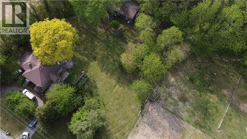 Expansive property featuring a brown roofline, abundant mature trees, a substantial green space, and a dedicated driveway - 535 Mcdowell Road E, Simcoe, ON 