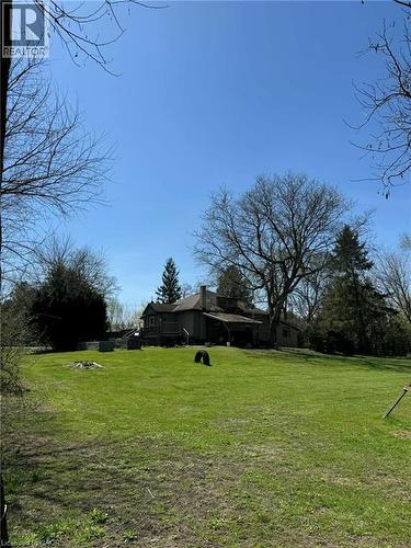 Expansive green lawn with a gentle slope leading to a traditional-style residence - 535 Mcdowell Road E, Simcoe, ON 