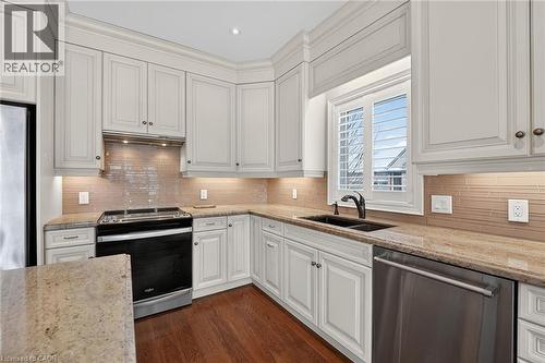 Breakfast bar and solid surface countertops - 1 Cedar Drive, St. Davids, ON - Indoor Photo Showing Kitchen With Double Sink With Upgraded Kitchen