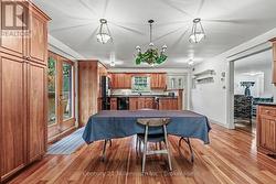 Open kitchen and dining area with cherry cabinets - 