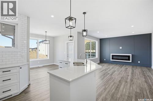 203 Sharma Lane, Saskatoon, SK - Indoor Photo Showing Kitchen With Fireplace With Double Sink