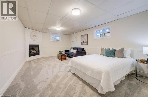 Basement 4th bedroom with lounge area and gas fireplace, a perfect spot for a teenager or in-law suite. - 66 Tupper Crescent, Kitchener, ON - Indoor Photo Showing Bedroom