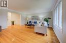 Main floor living room with gleaming, original hardwood flooring, bright windows and open to dining room - 66 Tupper Crescent, Kitchener, ON  - Indoor Photo Showing Living Room 