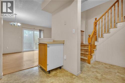 Kitchen with a textured ceiling, a chandelier, and light countertops - 26 Roehampton Crescent, Guelph, ON - Indoor Photo Showing Other Room