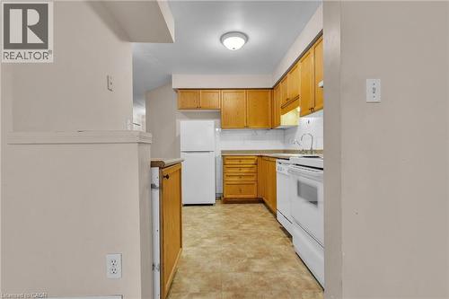 Kitchen with white appliances, light countertops, tasteful backsplash, and wood finish cabinetry - 26 Roehampton Crescent, Guelph, ON - Indoor Photo Showing Kitchen