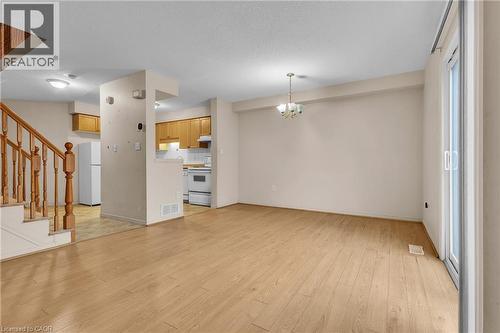 Unfurnished living room with suspended lighting and light wood-style flooring - 26 Roehampton Crescent, Guelph, ON - Indoor Photo Showing Other Room