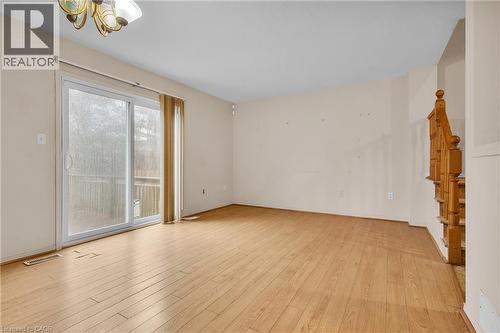 Unfurnished living room featuring light wood-type flooring and suspended lighting - 26 Roehampton Crescent, Guelph, ON - Indoor Photo Showing Other Room